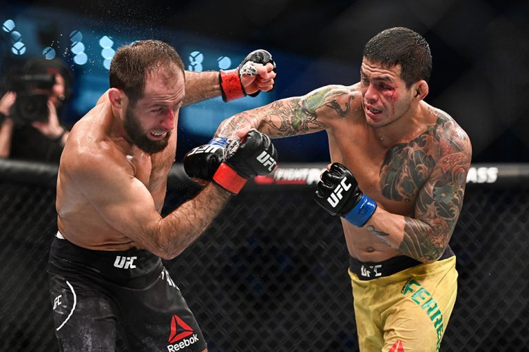 Sep 7, 2019; Abu Dhabi, UAE; Mairbek Taisumov (red gloves) fights Diego Ferreira (blue gloves) during UFC 242 at The Arena. Mandatory Credit: Per Haljestam-USA TODAY Sports