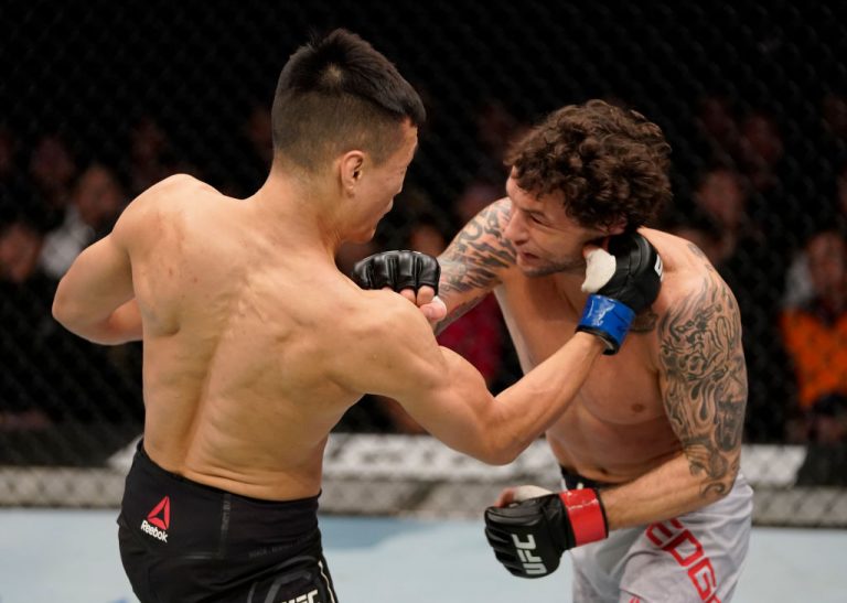 BUSAN, SOUTH KOREA - DECEMBER 21: (L-R) Chan Sung Jung of South Korea punches Frankie Edgar in their featherweight fight during the UFC Fight Night event at Sajik Arena 3 on December 21, 2019 in Busan, South Korea. (Photo by Jeff Bottari/Zuffa LLC via Getty Images)