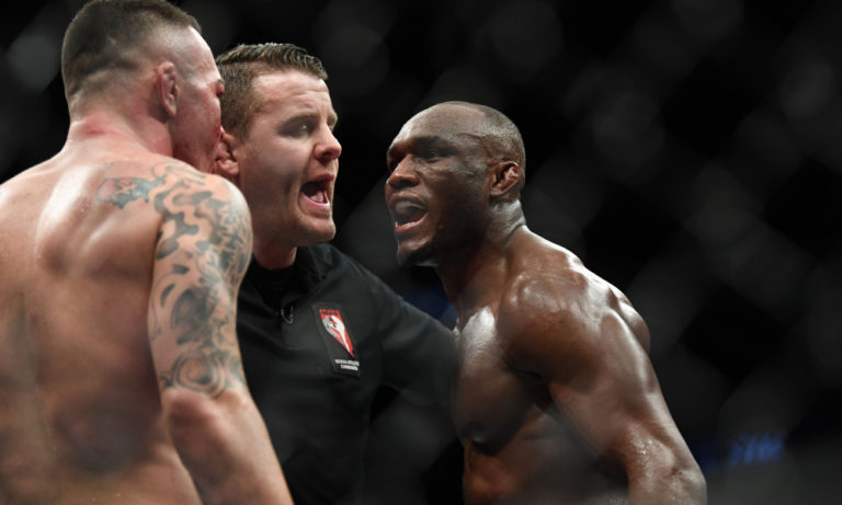 Dec 14, 2019; Las Vegas, NV, USA; The referee separates Kamaru Usman (right) and Colby Covington (left) during UFC 245 at T-Mobile Arena. Mandatory Credit: Stephen R. Sylvanie-USA TODAY Sports