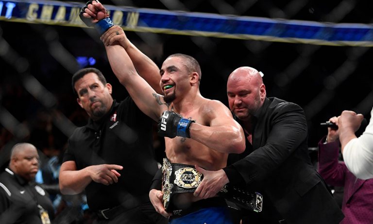 July 8, 2017; Las Vegas, NV, USA; Robert Whittaker (blue gloves) is awarded the belt from UFC president Dana White after defeating Yoel Romero (red gloves) during UFC 213 at T-Mobile Arena. Mandatory Credit: Kyle Terada-USA TODAY Sports