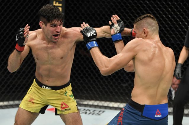 JACKSONVILLE, FLORIDA - MAY 09: (L-R) Vicente Luque punches Niko Price in their welterweight fight during the UFC 249 event at VyStar Veterans Memorial Arena on May 09, 2020 in Jacksonville, Florida. (Photo by Jeff Bottari/Zuffa LLC)